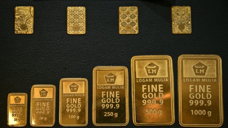 Gold nears $5,000, silver shines as stocks churn to end turbulent week