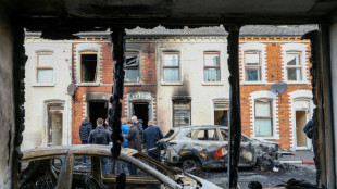 Belfast girds for more violence after stabbing suspect held